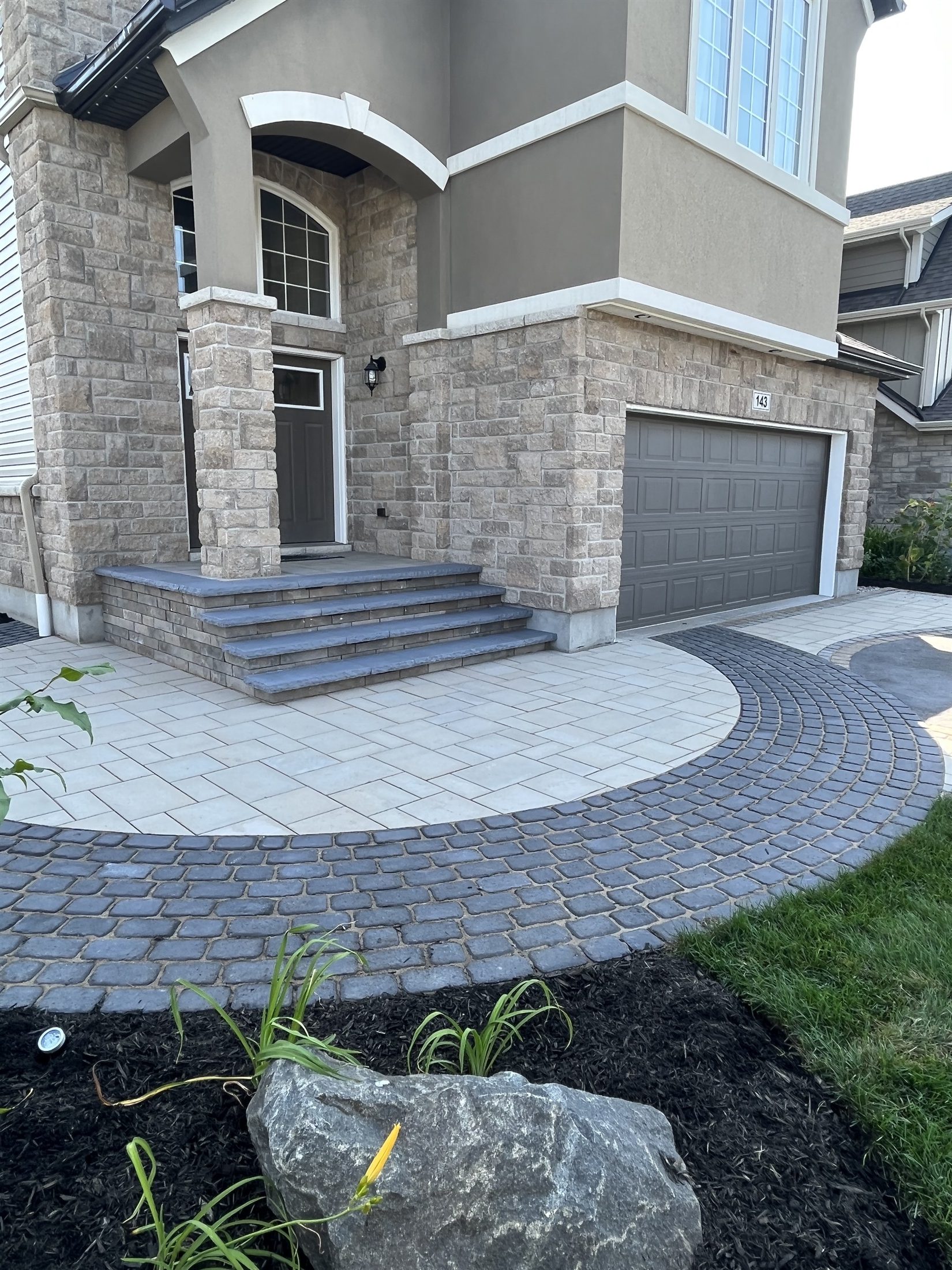 Interlock walkway and driveway with black and natural coloured stones.